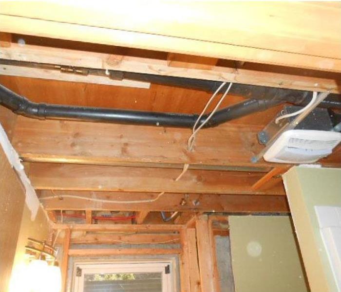 removed ceiling and wall panels, showing plumbing