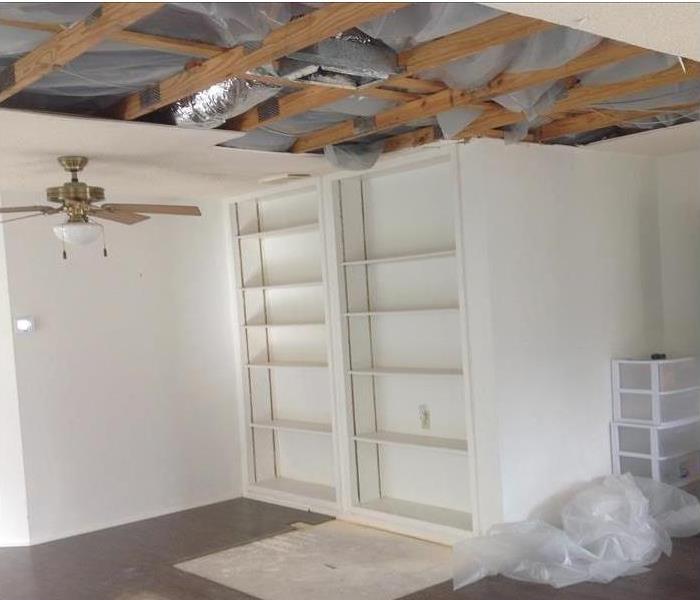 poly sheeting showing through the exposed ceiling, ceiling joists visible