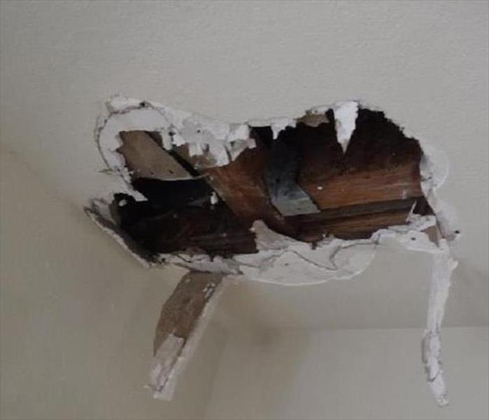 hole in ceiling, drywall hanging, shown timbers above