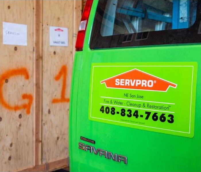 Back of a SERVPRO van by wooden boxes holding contents