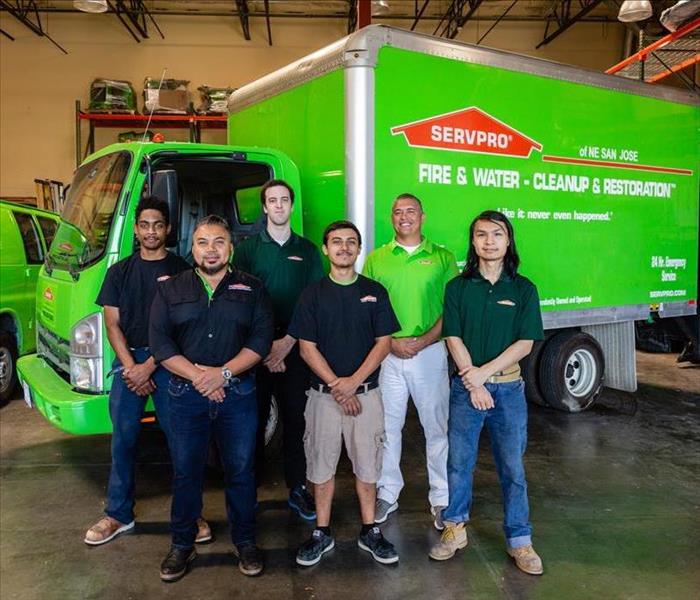 servpro team posing in front of truck in warehouse
